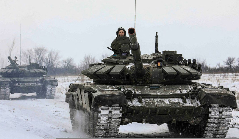 Russian servicemen drive tanks during military exercises